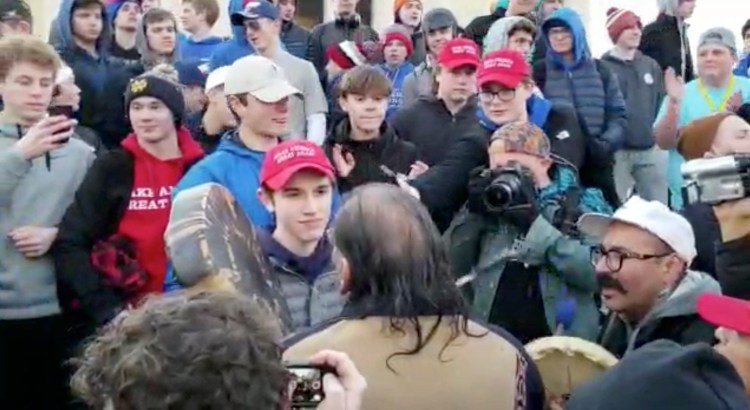 A confrontation between a teen, later identified as Nicholas Sandmann,  wearing a "Make America Great Again" hat and an elderly Native American singing and playing a drum at the Lincoln Memorial in January.