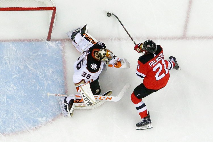 Anaheim Ducks goaltender John Gibson (36) protects his net against New Jersey Devils right wing Kyle Palmieri (21) during the second period of the Ducks' 3-2 win Saturday in Newark, New Jersey.