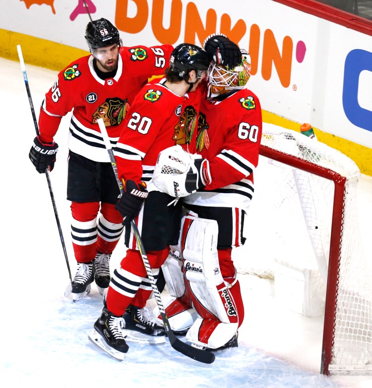Chicago Blackhawks left wing Brandon Saad (20) celebrates with oaltender Collin Delia g(60) at the end their 8-5 win over the Washington Capitals on Monday in Chicago
