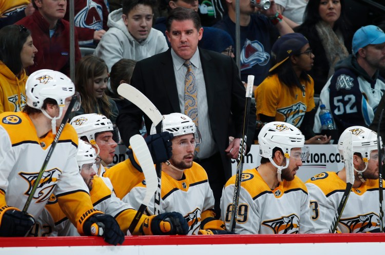 Nashville Predators Coach Peter Laviolette, back, directs his players in the second period of an NHL hockey game against the Colorado Avalanche on Monday in Denver. Laviolette earned his 600th career victory Monday.