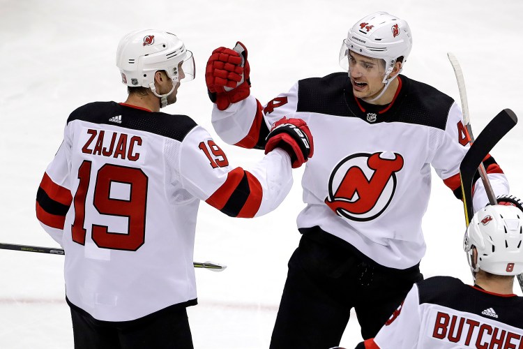 New Jersey Devils' Travis Zajac celebrates his goal with Miles Wood during the first period of the Devils' 6-3 win over Pittsburgh on Monday in Pittsburgh.