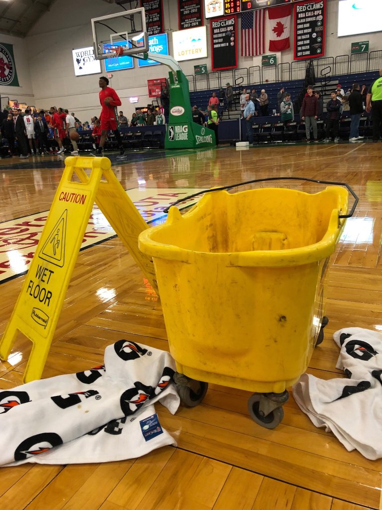 A bucket collects water dripping from the leaky roof at the Portland Expo, where Thursday night's basketball game between the Maine Red Claws and Grand Rapids had to be postponed.