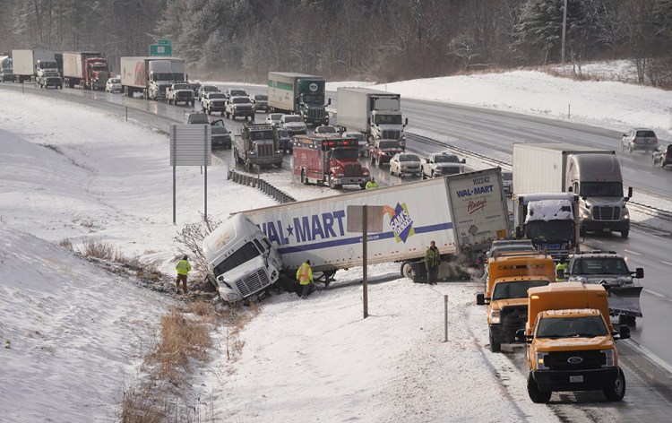 Traffic backs up as it is routed around a jackknifed tractor trailer truck in the northbound lane of the Maine Turnpike near mile marker 33 in Biddeford on Thursday morning. 