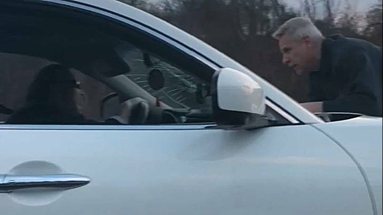 Video shows two men who allegedly got into a road rage incident  in which one drove at speeds of up to 70 mph with the other clinging to the hood of his vehicle