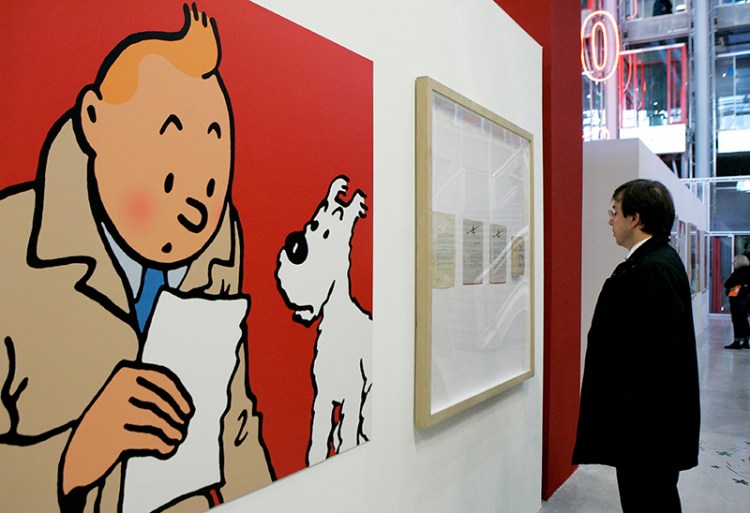 A visitor looks at original letters and an enlarged cartoon of Tintin by Belgian cartoonist Herge at Paris' Pompidou Cultural Center in 2006.