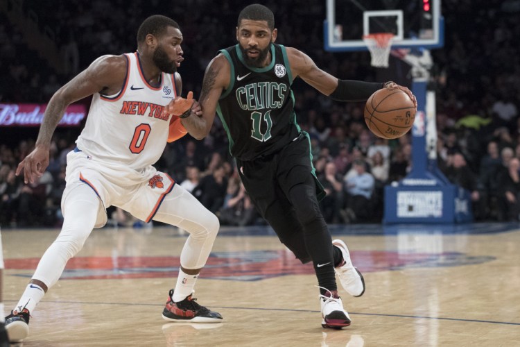 Celtics guard Kyrie Irving, who was cheered by the crowd in New York, drives to the basket against Knicks guard Kadeem Allen during Boston's 113-99 win Friday.