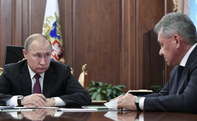 Russian President Vladimir Putin, left, speaks to Defense Minister Sergei Shoigu in Moscow on Saturday. The collapse of the nuclear arms treaty has raised fears about a Cold War repeat. AP