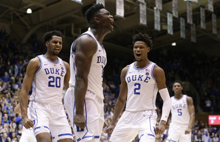 Duke's Zion Williamson, center, celebrates with Marques Bolden, left, and Cam Reddish during a 91-61 win Saturday against St. John's.