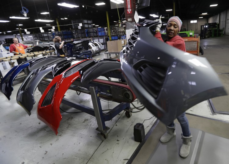 Mari Keels transfers a front end of a Chevrolet Cruze at Jamestown Industries, in Youngstown, Ohio, on Nov. 28, 2018. Jamestown Industries, which supplies front and rear bumper covers for the Cruze, hopes its efforts to secure new business will allow its Youngstown plant to keep going. But the plant is down from three shifts to one and GM is still its biggest customer.