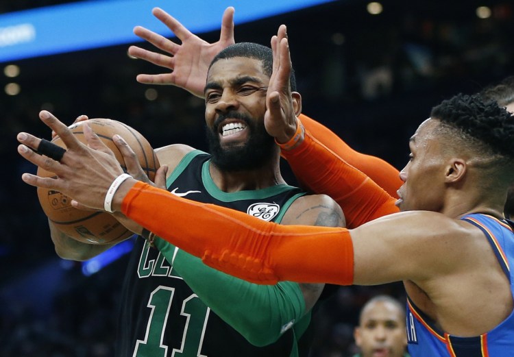 Oklahoma City's Russell Westbrook, right, defends against Boston's Kyrie Irving, left, during the first half of the Celtics' 134-129 win Sunday in Boston.