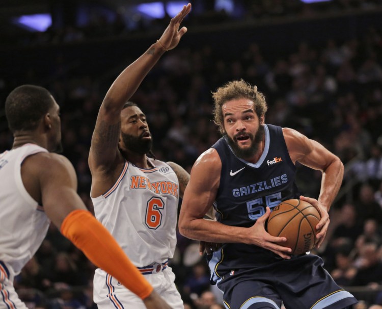 Memphis's Joakim Noah, right, drives to the basket during the first half of the Grizzlies' 96-84 win over the New York Knicks on Sunday in New York.