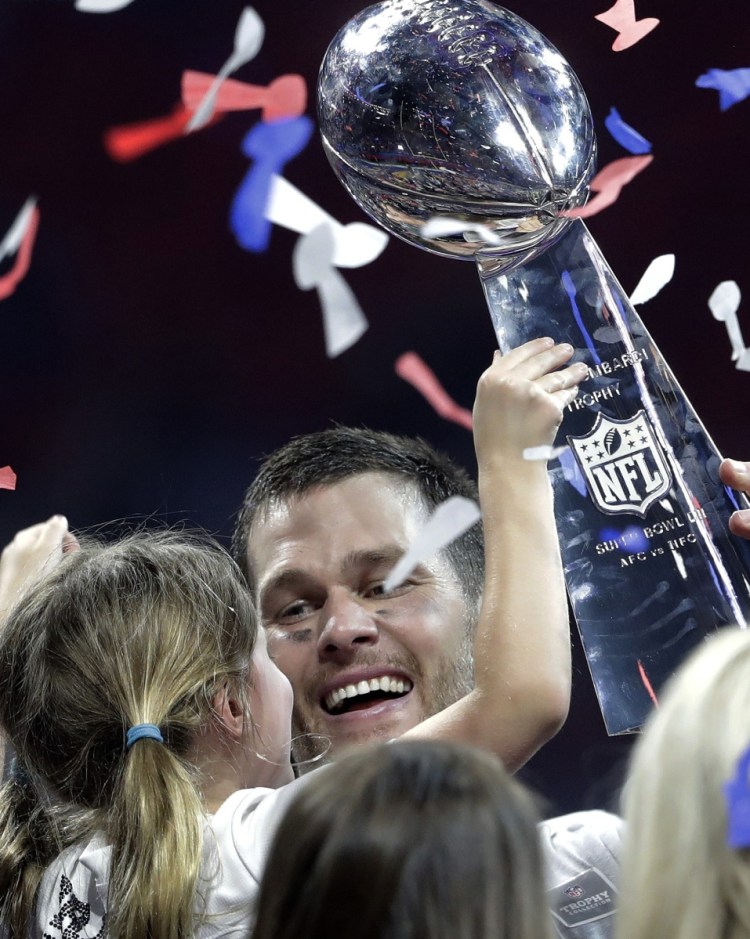In one hand the trophy, in the other his daughter, Vivian. Life is good for Tom Brady and his New England Patriots, who added to their dynastic legacy Sunday night by beating the Rams.