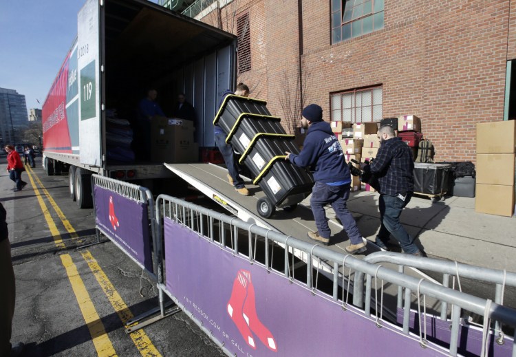 Workers load a case onto the Boston Red Sox baseball team's truck outside Fenway Park, Monday, Feb. 4, 2019, in Boston. The truck will be heading to JetBlue Park in Fort Myers, Fla. for the players' spring training. (AP Photo/Steven Senne)