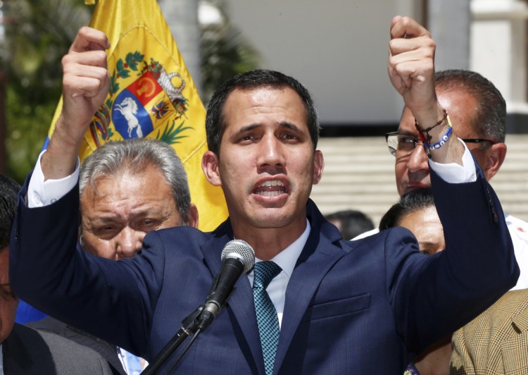 Opposition leader Juan Guaido, who has declared himself the interim president of Venezuela, speaks during a press conference Monday on the steps of the National Assembly in Caracas. He thanked European governments for their support.