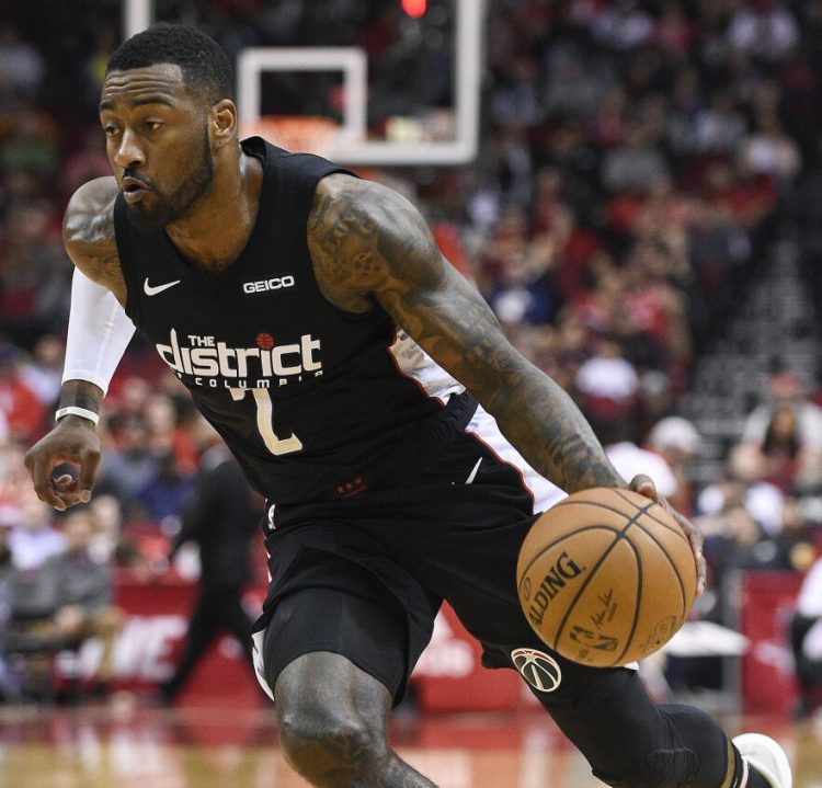 Washington guard John Wall will be sidelined for more than another year because he ruptured his left Achilles tendon after slipping and falling at home.