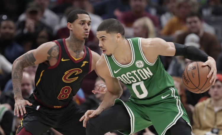 Boston's Jayson Tatum drives past Cleveland's Jordan Clarkson during the Celtics' 103-96 win Tuesday in Cleveland. Tatum finished with 25 points.