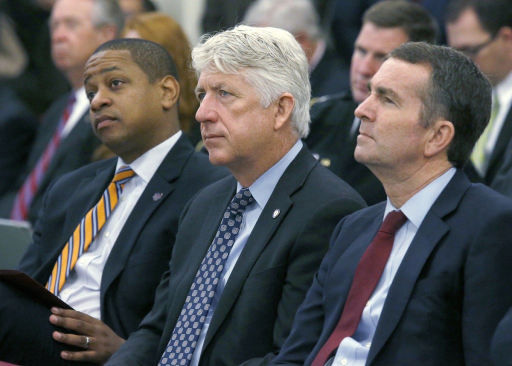From left, Lt. Governor-elect Justin Fairfax, Attorney General-elect Mark Herring and Governor-elect Ralph Northam listen as Virginia Governor Terry McAuliffe addresses a joint meeting of the House and Senate appropriations committees in Richmond, Va., in 2017. With Virginia's top three elected officials engulfed in scandal, fellow Democrats were rendered practically speechless, uncertain of how to thread their way through the racial and sexual allegations and their tangled political implications.