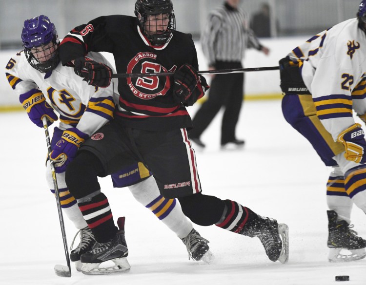 Scarborough's Nolan Matthews tries to fend off Kevin Connolly of Cheverus in Thursday's game at Portland. Matthews scored three goals as the Red Storm ended a four-game losing streak with a 5-0 win to even their record at 6-6-1.