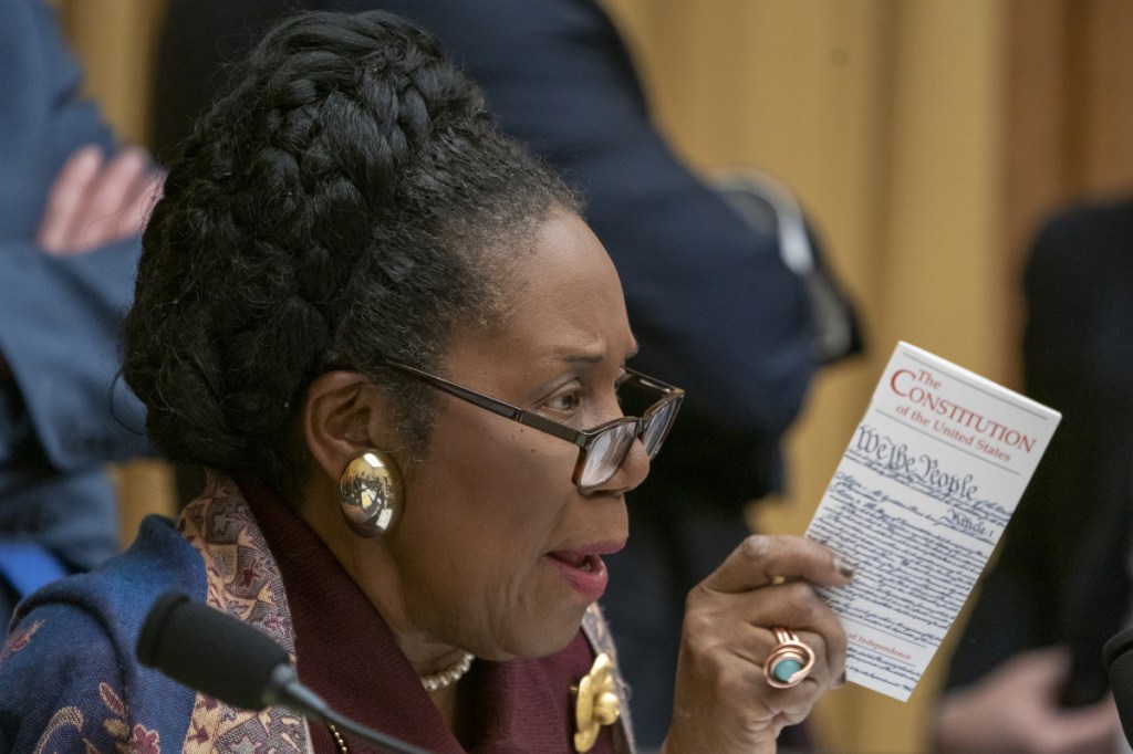 House Judiciary Committee member Rep. Sheila Jackson Lee, D-Texas, holds a pocket-size copy of The Constitution as she questions Acting Attorney General Matthew Whitaker on Capitol Hill on Friday in Washington.