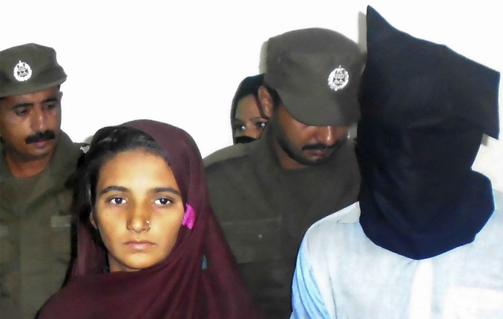 Asia Bibi, left, and her boyfriend, Shahid Lashari, appear at a police station in Pakistan in 2017. Bibi, a Christian, was acquitted of blasphemy but remains threatened by extremists.
Associated Press/Iram Asim