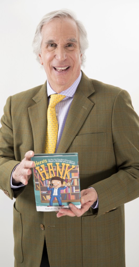 Actor and author Henry Winkler holds his latest book in the "Here's Hank" series.