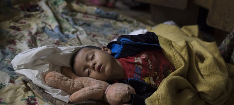 A Central American child who is traveling with a caravan of migrants sleeps at a shelter in Tijuana, Mexico, knowing  that they face possible separation from their children and detention.
