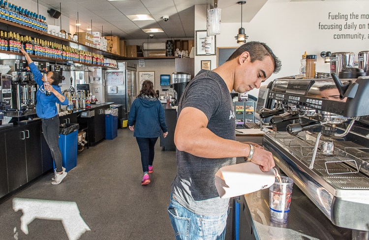 Tulio DeAlmeida makes an iced macchiato at Aroma Joe's in Auburn. There are 63 locations in six states.