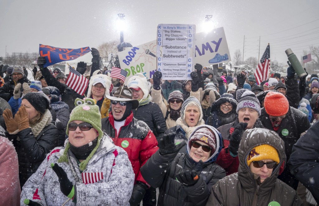 Klobuchar supporters cheer as a DJ takes the stage in a snowy Boom Park in Minneapolis.