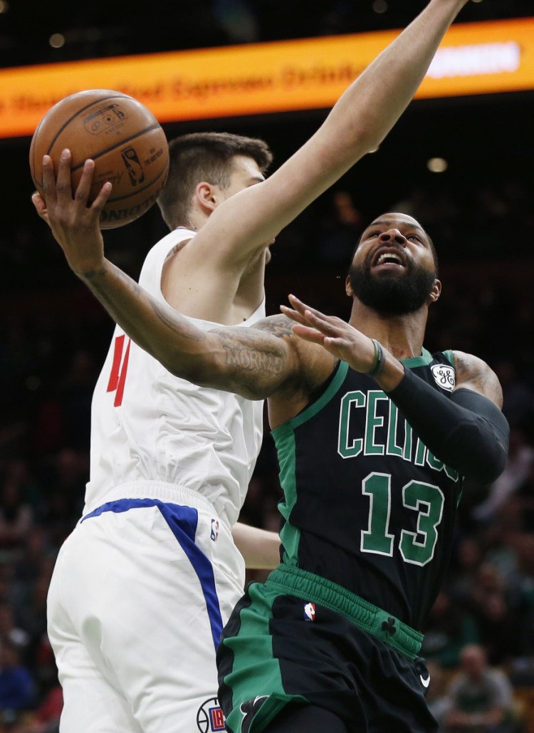 Boston's Marcus Morris, right, takes a shot during Saturday's fall-from-ahead loss to the Clippers. Morris sees a lack of comaraderie within the team.