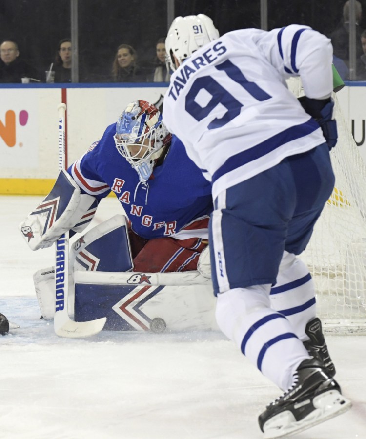 Rangers goaltender Alexandar Georgiev makes one of his 55 saves on a shot by Toronto's John Tavares in the first period Sunday night at New York.