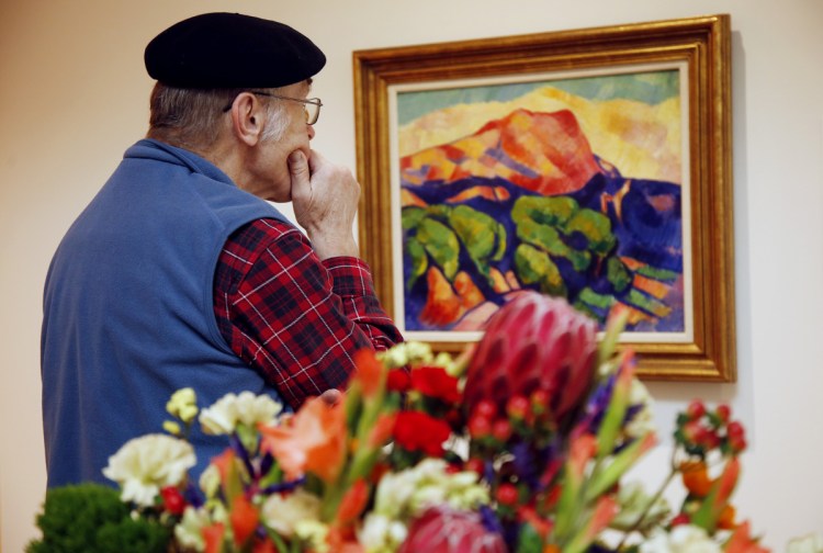 PORTLAND, ME - FEBRUARY 13: George Viles of Cape Elizabeth studies an oil on canvas painting "Unititled (Mont Sainte Victoire), circa 1925 by Marsden Hartley during a tour of Art in Bloom at Portland Museum of Art. The painting inspired the floral design by John Sundling of Plant Office. (Staff photo by Derek Davis/Staff Photographer)