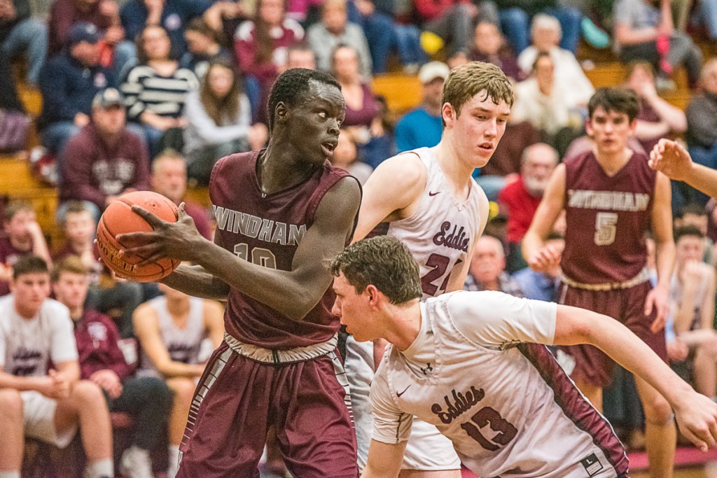 Dierhow Bol of Windham looks for an open teammate while defended by Edward Little's Cam Yorke, front, during their Class AA North quarterfinal Wednesday in Auburn. Edward Little won, 45-34.
