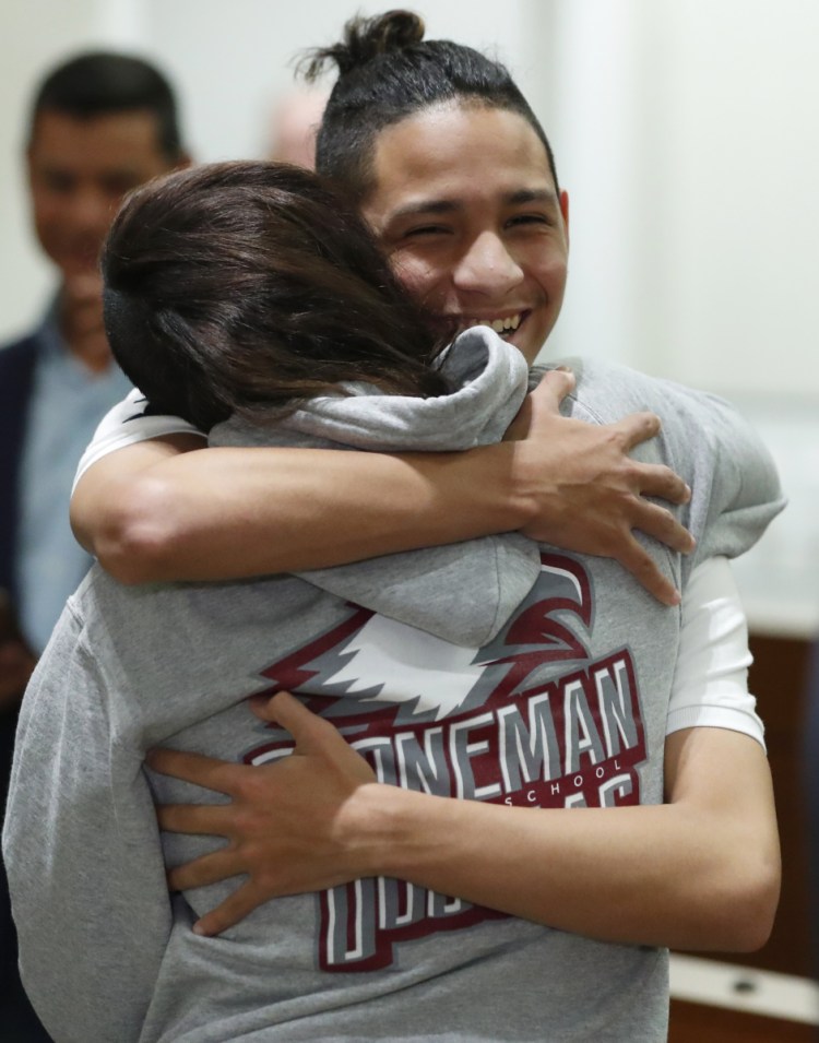 Anthony Borges, rear, who was shot during the Parkland, Fla., school shooting, hugs Marianne Sheehan after a news conference with Florida governor Ron DeSantis on Wednesday.