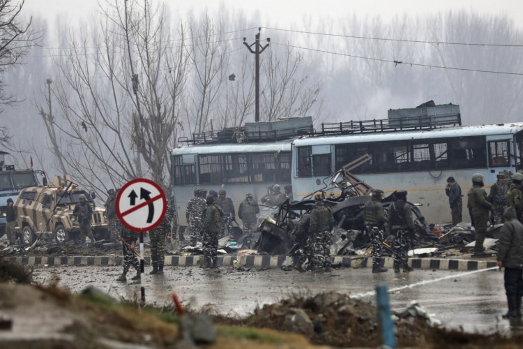Indian paramilitary soldiers stand by the wreckage of a bus after an explosion in Pampore, Indian-controlled Kashmir on Thursday.