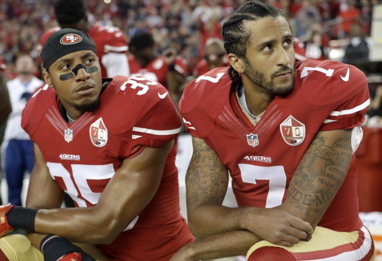 Eric Reid, left, and Colin Kaepernick settled their collusion grievances with the NFL on Friday. The pair filed grievances against the NFL, saying they were blacklisted for protest during the national anthem.