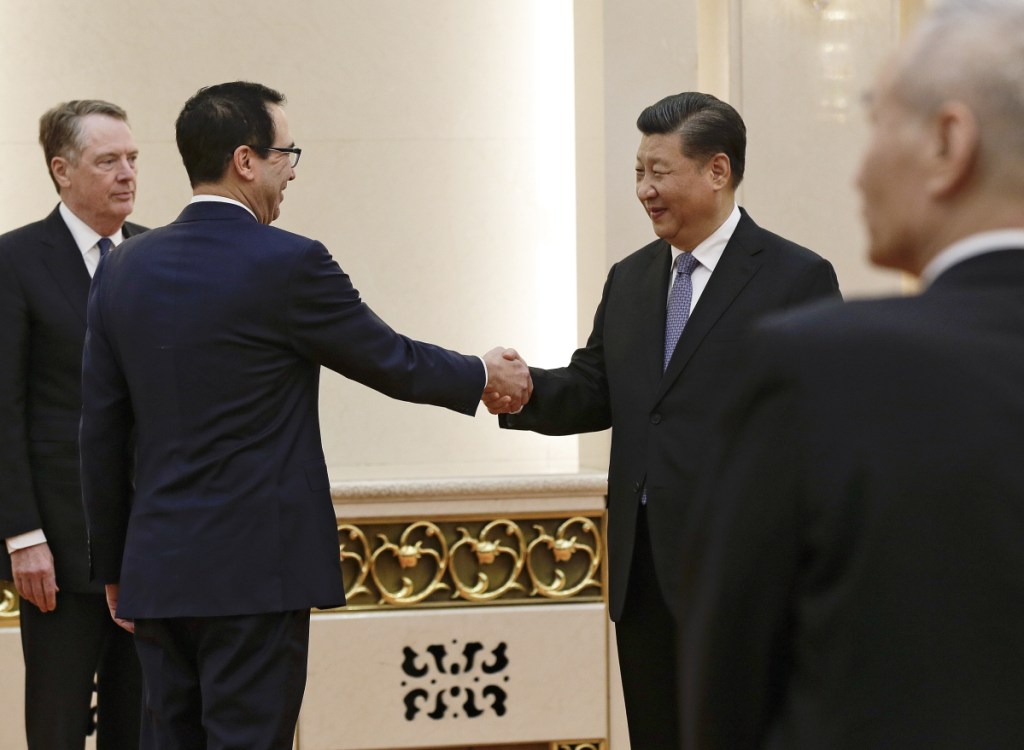 Accompanied by U.S. Trade Representative Robert Lighthizer, left, U.S. Treasury Secretary Steven Mnuchin shakes hands with Chinese President Xi Jinping at the Great Hall of the People in Beijing on Friday.