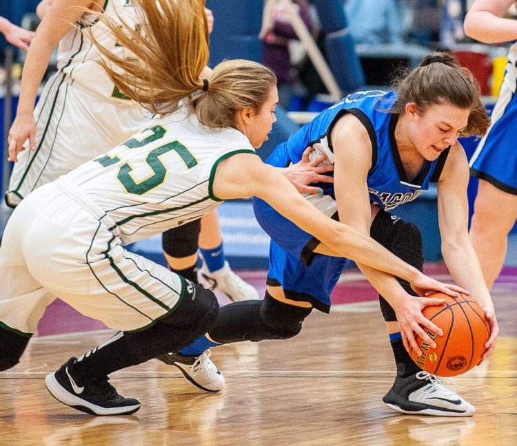 Rangeley's Olivia Pye, left, and Seacoast Christian's Katie Pilkington dive for a loose ball Saturday morning during a Class D South quarterfinal at the Augusta Civic Center. Rangeley won, 56-23.