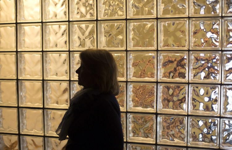 Behind Nancy Thompson of Cape Elizabeth is a glass wall honoring the memory of her son Timmy at the Center for Grieving Children in Portland.