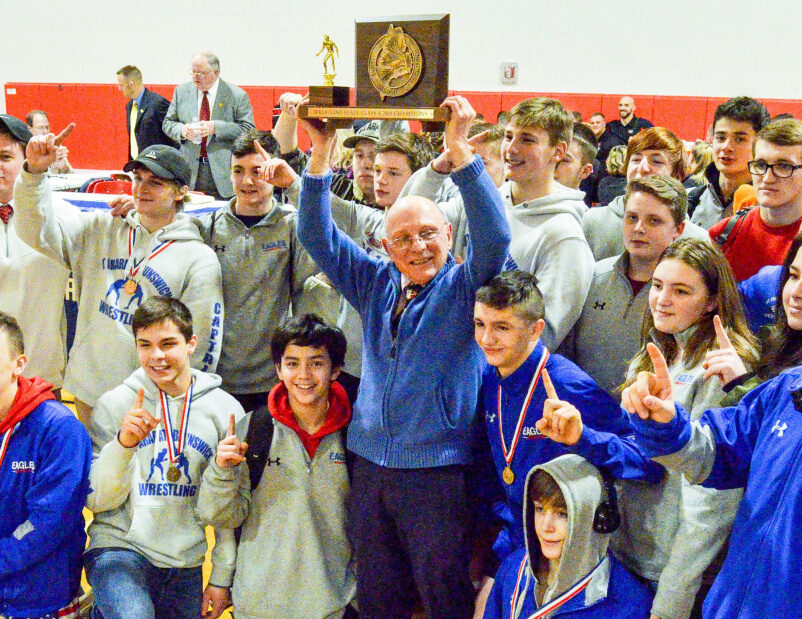 The Mt. Ararat/Brunswick wrestling team celebrates after winning the Class A wrestling state championship on Saturday at Cony High School in Augusta.