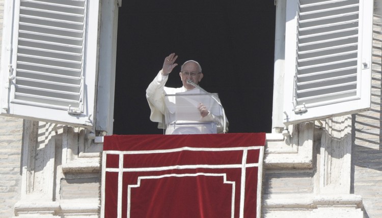 Pope Francis delivers his blessing during the Angelus noon prayer at the Vatican on Sunday. More than 100 top bishops will convene at the Vatican this week to address the issue of clergy sex abuse.