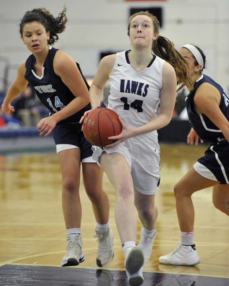 Marshwood guard Kayla Goodwin drives into the lane after eluding York's Hannah Gennaro during the Hawks' 59-37 win in the Class A South quarterfinals on Monday at the Portland Expo.