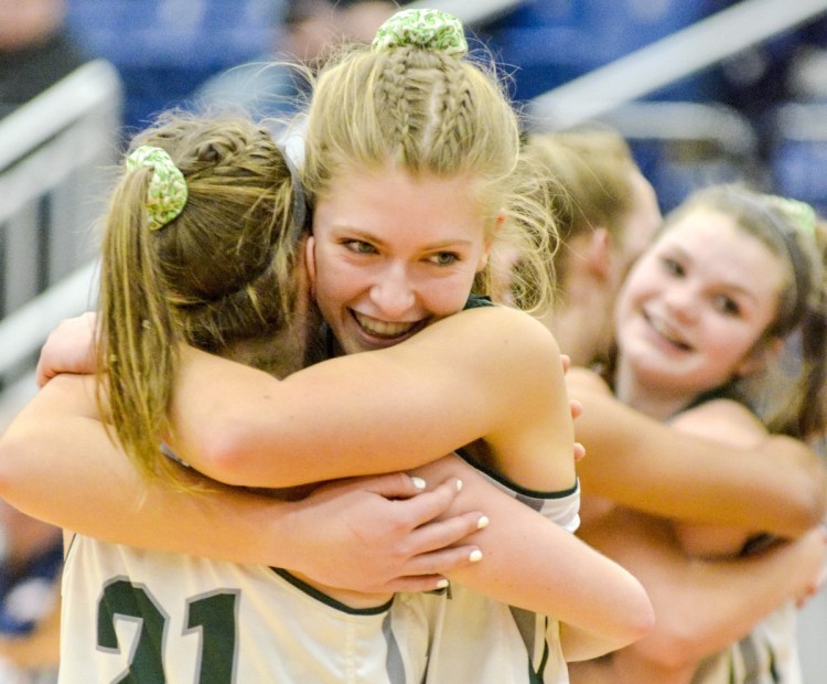 Winthrop players hug after winning a Class C South quarterfinal over Old Orchard Beach on Tuesday at the Augusta Civic Center.
