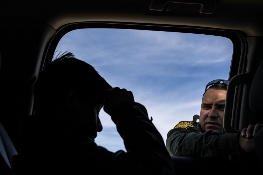 Border Patrol agent Daniel Hernandez speaks with a 14-year-old boy from Guatemala who was arrested after illegally crossing the U.S.-Mexico border alone in Organ Pipe Cactus National Monument National Monument in Ajo, Ariz.
