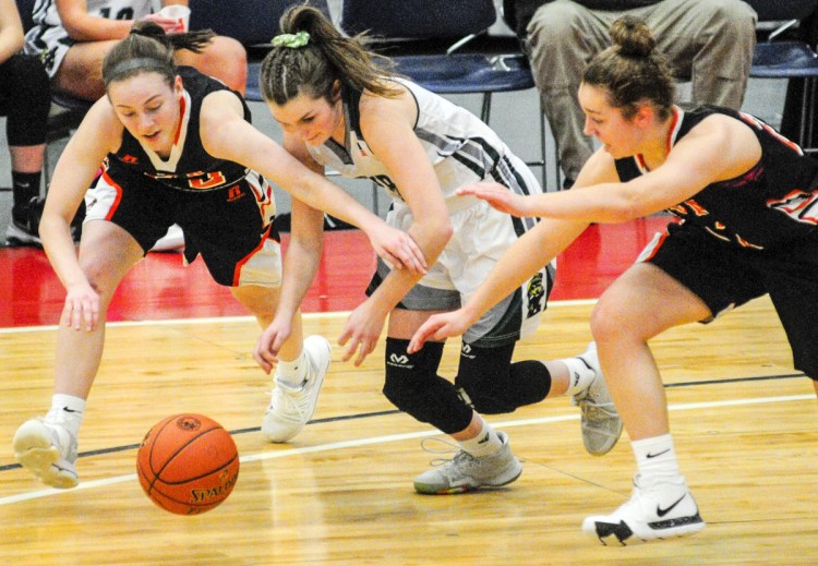 North Yarmouth Academy's Catherine Reid, left, and Serena Mower battle Winthrop's Maddie Perkins for a loose ball during their Class C South semifinal Thursday at the Augusta Civic Center. (Staff photo by Joe Phelan/Staff Photographer)