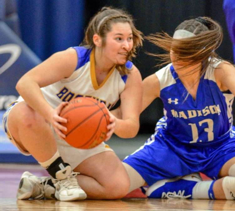 Boothbay's Madison Faulkingham beats Emily Edgerly of Madison to a loose ball during their Class C South semifinal Thursday at the Augusta Civic Center. Boothbay won, 55-23.