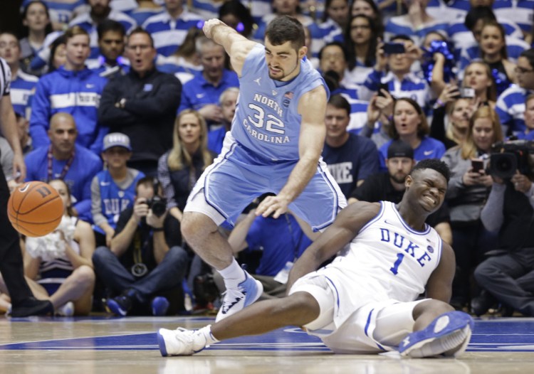 Zion Williamson of Duke falls to the floor Wednesday night after trying to plant his left foot. His sneaker fell apart and Williamson landed in an awkward position. He suffered a mild right knee sprain and isn't expected to be out of the lineup for long.