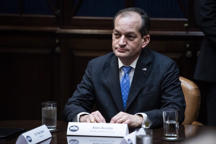 Labor Secretary Alex Acosta listens to President Trump during a meeting about health care at the White House on Jan. 23.