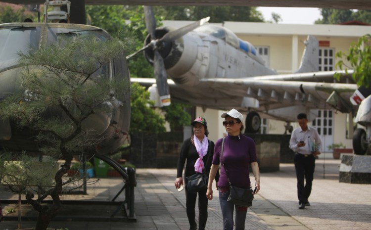 Visitors walk next to American aircraft at the Vietnam Military History Museum in Hanoi, Vietnam, last week. The Vietnamese capital once trembled as waves of American bombers unleashed their payloads, but when Kim Jong Un arrives here for his summit with President Trump he won't find rancor toward a former enemy. Instead, the North Korean leader will get a glimpse at the potential rewards of reconciliation.