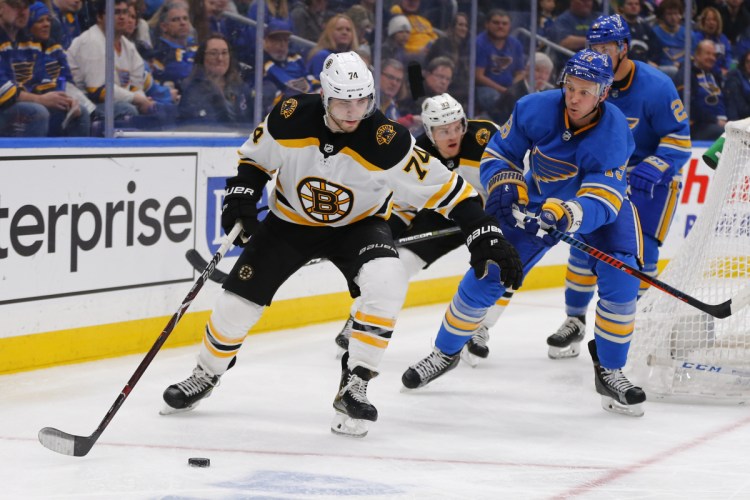 Boston's Jake DeBrusk controls the puck against St. Louis' Jay Bouwmeester during the third period of the Bruins' 2-1 shootout loss on Saturday in St. Louis.