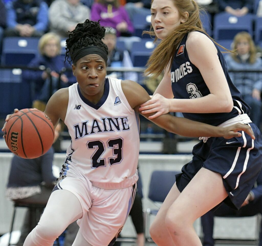 AUGUSTA, ME - FEBRUARY 24: University of Maine's Tanesha Sutton dribbles around State University of New York at Stony Brook's Oksana Gouchie-Provencher during a basketball game on Sunday February 24, 2019  in Augusta. Staff photo by Andy Molloy